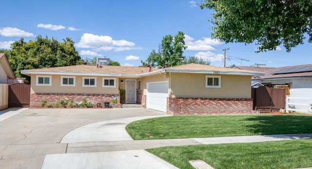 2983 E Northdale Ave, Fresno, CA 93726 - ranch-style home with a gate, stucco siding, brick siding, an attached garage, and driveway