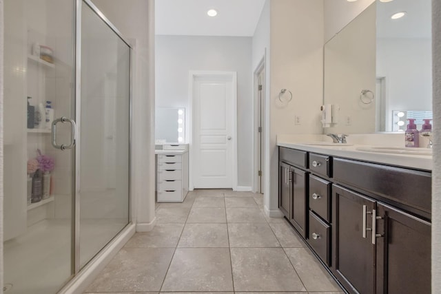 bathroom with double vanity, a stall shower, and tile patterned flooring