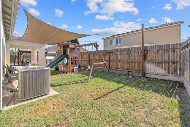 view of yard with central AC unit and a playground