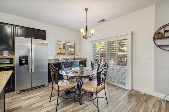 2865 Maine Ave, Clovis, CA 93619 - dining room featuring a chandelier, light wood-style floors, and baseboards
