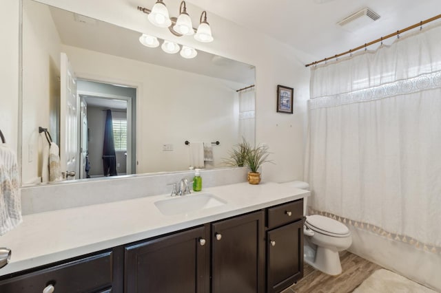 2865 Maine Ave, Clovis, CA 93619 - full bath featuring vanity, toilet, wood finished floors, and shower / bath combination with curtain