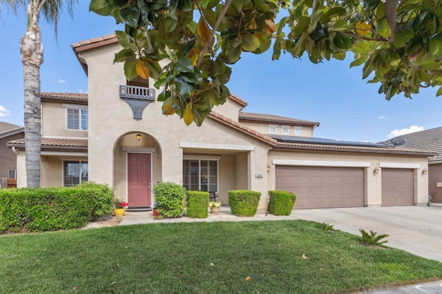 2865 Maine Ave, Clovis, CA 93619 - mediterranean / spanish-style house featuring stucco siding, driveway, a tiled roof, a front lawn, and an attached garage