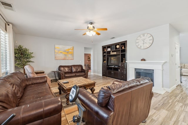 2865 Maine Ave, Clovis, CA 93619 - living room with a ceiling fan, a glass covered fireplace, baseboards, and light wood-type flooring