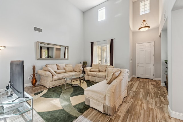 2865 Maine Ave, Clovis, CA 93619 - living area featuring a towering ceiling, light wood-type flooring, and baseboards