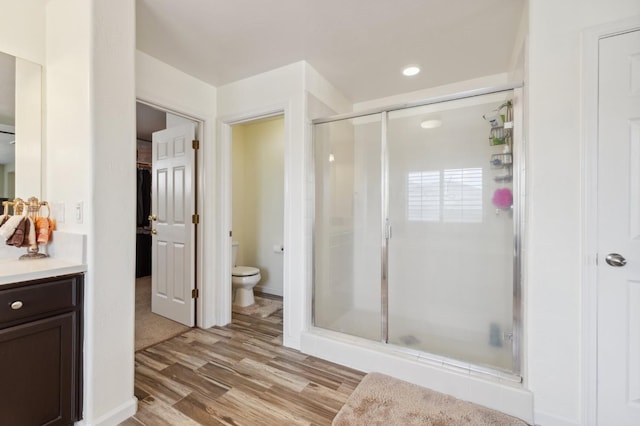 2865 Maine Ave, Clovis, CA 93619 - bathroom with a stall shower, toilet, wood finished floors, and vanity