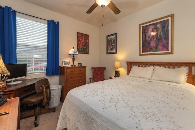 carpeted bedroom featuring multiple windows, an office area, and a ceiling fan