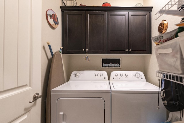 laundry area with washing machine and dryer and cabinet space