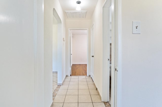 324 E San Mateo St, Avenal, CA 93204 - hall with arched walkways, light tile patterned floors, and baseboards