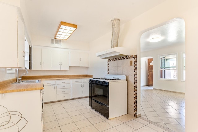 324 E San Mateo St, Avenal, CA 93204 - kitchen featuring gas range, a sink, light tile patterned floors, light countertops, and white cabinetry