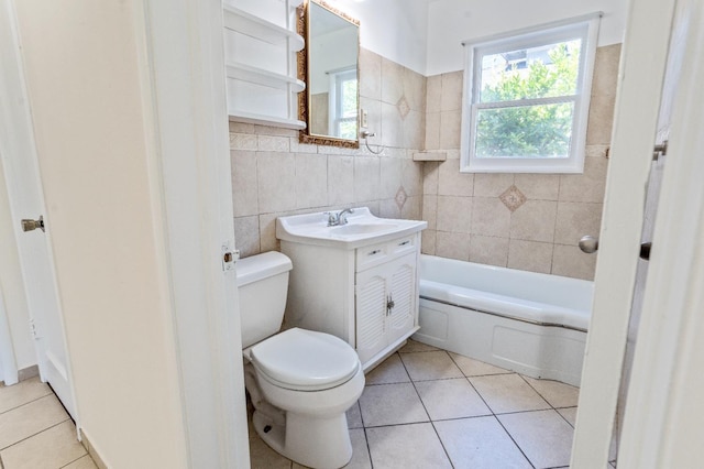 324 E San Mateo St, Avenal, CA 93204 - full bathroom with tile patterned flooring, tile walls, toilet, a tub to relax in, and vanity