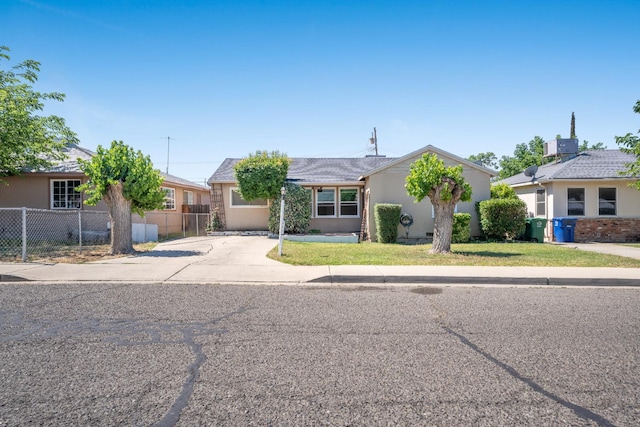 324 E San Mateo St, Avenal, CA 93204 - view of front of home with stucco siding and concrete driveway