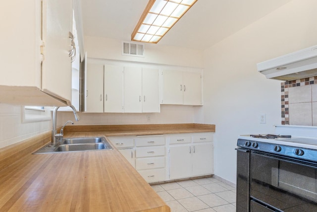 324 E San Mateo St, Avenal, CA 93204 - kitchen with a sink, gas stove, white cabinetry, baseboards, and butcher block counters