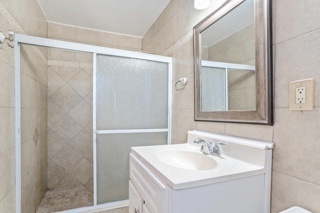 324 E San Mateo St, Avenal, CA 93204 - full bathroom featuring a shower stall, vanity, and tile walls