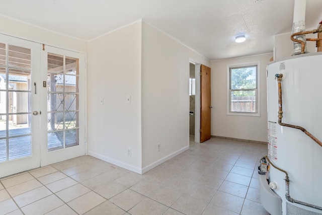 324 E San Mateo St, Avenal, CA 93204 - empty room featuring gas water heater, french doors, light tile patterned floors, baseboards, and a textured ceiling