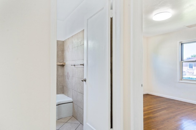 324 E San Mateo St, Avenal, CA 93204 - bathroom featuring a shower, wood finished floors, and a bath