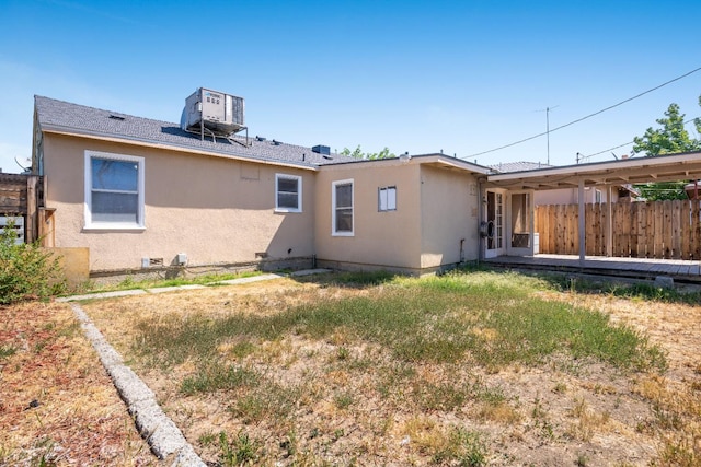 324 E San Mateo St, Avenal, CA 93204 - rear view of house featuring central air condition unit, stucco siding, and fence