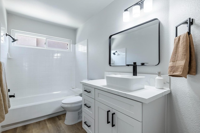 1801 E Omaha Ave, Fresno, CA 93720 - bathroom featuring wood finished floors, toilet, tub / shower combination, and vanity
