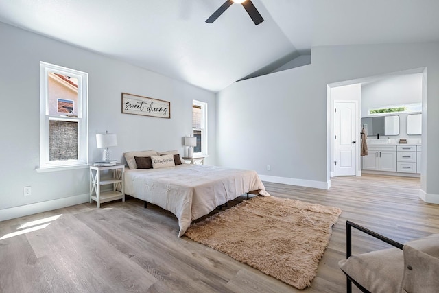1801 E Omaha Ave, Fresno, CA 93720 - bedroom featuring lofted ceiling, light wood-type flooring, multiple windows, connected bathroom, and baseboards