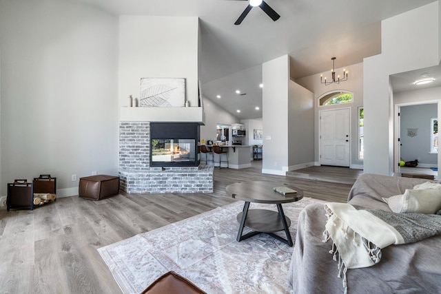 1801 E Omaha Ave, Fresno, CA 93720 - living area featuring high vaulted ceiling, wood finished floors, a chandelier, a ceiling fan, and baseboards