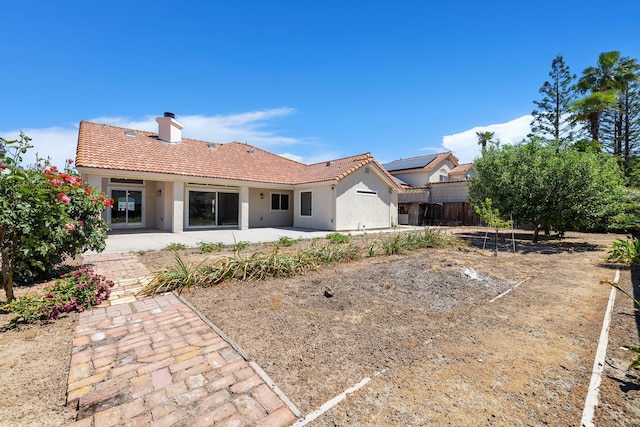 1801 E Omaha Ave, Fresno, CA 93720 - rear view of property featuring a patio, fence, a tile roof, stucco siding, and a chimney