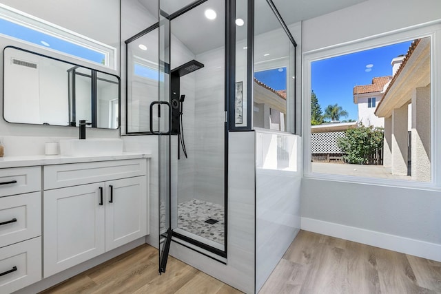 1801 E Omaha Ave, Fresno, CA 93720 - bathroom featuring plenty of natural light, wood finished floors, a shower stall, and baseboards
