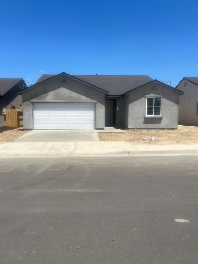 13416 Fourth St Unit Lot9, Parlier, CA 93648 - ranch-style house with an attached garage, stucco siding, and driveway