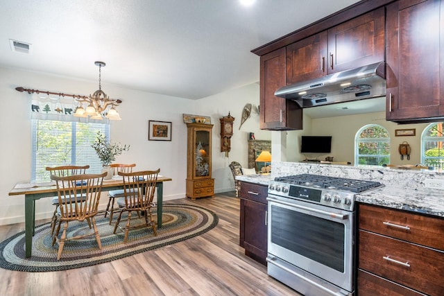39398 Robin, Bass Lake, CA 93604 - kitchen with stainless steel range with gas stovetop, under cabinet range hood, wood finished floors, a chandelier, and light stone countertops