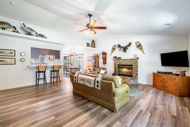 39398 Robin, Bass Lake, CA 93604 - living area featuring ceiling fan, wood finished floors, a fireplace, lofted ceiling, and baseboards