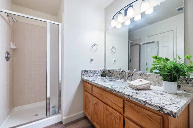 39398 Robin, Bass Lake, CA 93604 - bathroom featuring a stall shower, wood finished floors, vanity, and baseboards