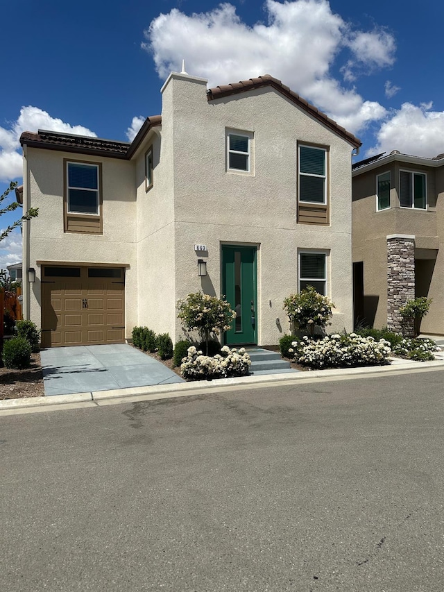663 Farmhouse Ln, Clovis, CA 93619 - view of front of home with stucco siding, an attached garage, concrete driveway, and a tiled roof