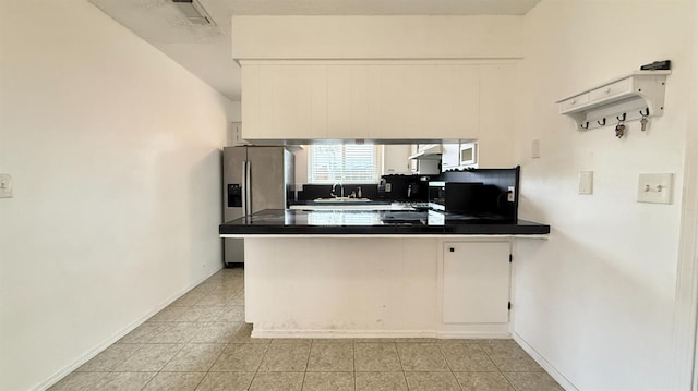 1380 Elaine Dr, Hanford, CA 93230 - kitchen with ventilation hood, a sink, a peninsula, dark countertops, and light tile patterned floors