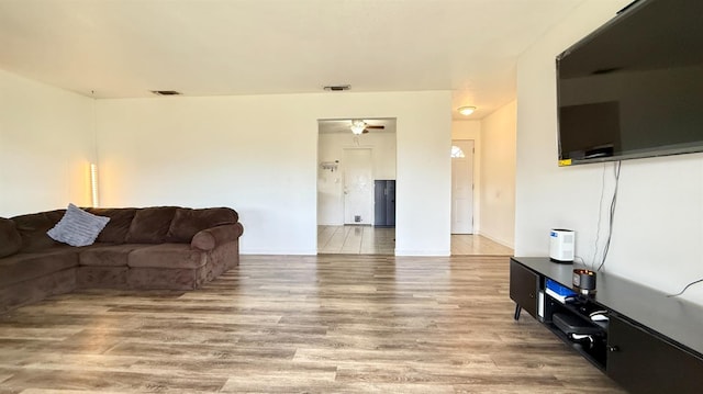 1380 Elaine Dr, Hanford, CA 93230 - living room with wood finished floors, a ceiling fan, and baseboards