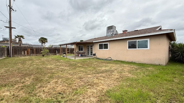 1380 Elaine Dr, Hanford, CA 93230 - back of property with stucco siding, a patio, french doors, and central AC