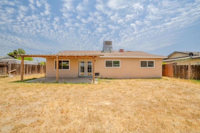 1380 Elaine Dr, Hanford, CA 93230 - rear view of house with french doors, stucco siding, a fenced backyard, and a patio area