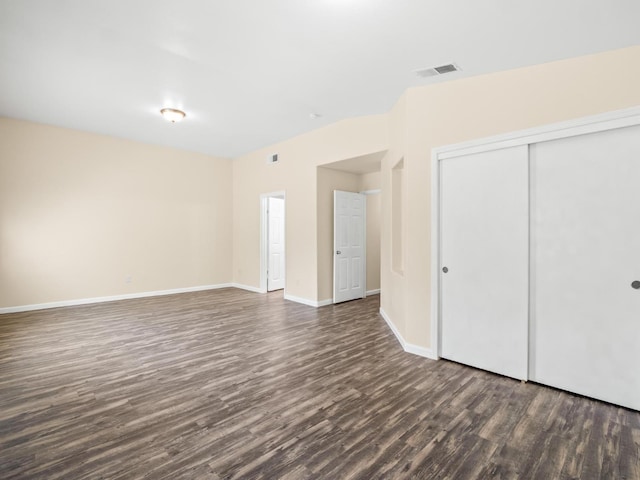 5611 W Carmen Ave, Fresno, CA 93722 - unfurnished bedroom featuring dark wood finished floors, a closet, and baseboards