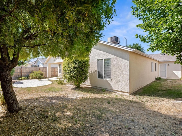 5611 W Carmen Ave, Fresno, CA 93722 - back of house featuring fence and stucco siding