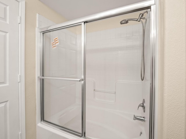 5611 W Carmen Ave, Fresno, CA 93722 - full bathroom featuring bath / shower combo with glass door