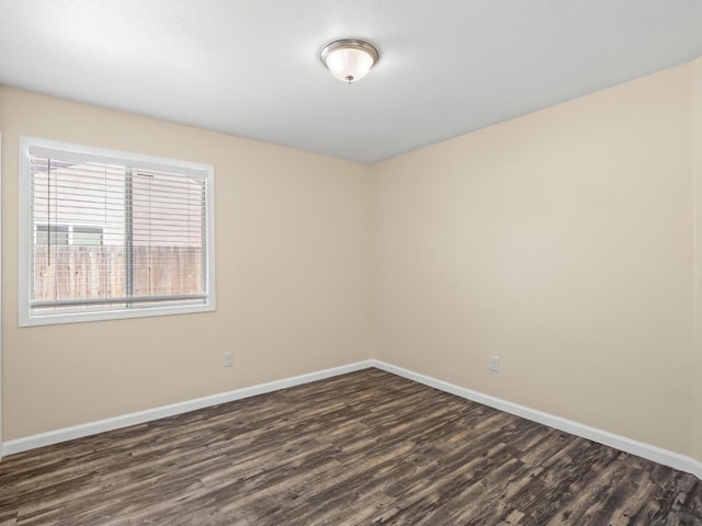 5611 W Carmen Ave, Fresno, CA 93722 - spare room featuring dark wood-style floors and baseboards