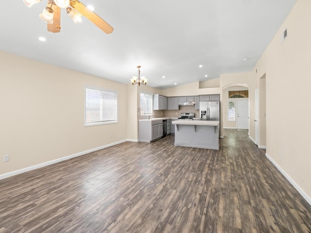 5611 W Carmen Ave, Fresno, CA 93722 - kitchen featuring gray cabinets, appliances with stainless steel finishes, under cabinet range hood, open floor plan, and dark wood-style floors