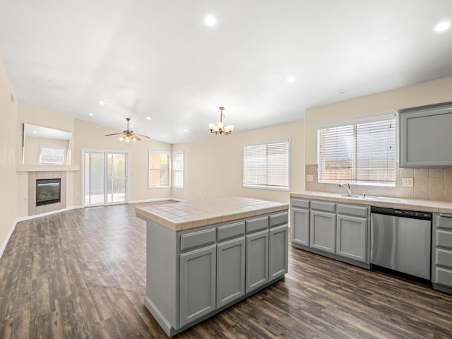 5611 W Carmen Ave, Fresno, CA 93722 - kitchen with dishwasher, gray cabinets, tile counters, recessed lighting, and vaulted ceiling