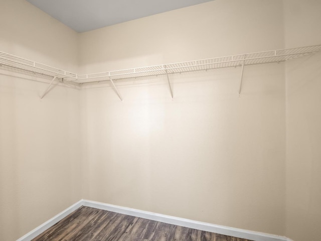 5611 W Carmen Ave, Fresno, CA 93722 - walk in closet featuring dark wood-type flooring