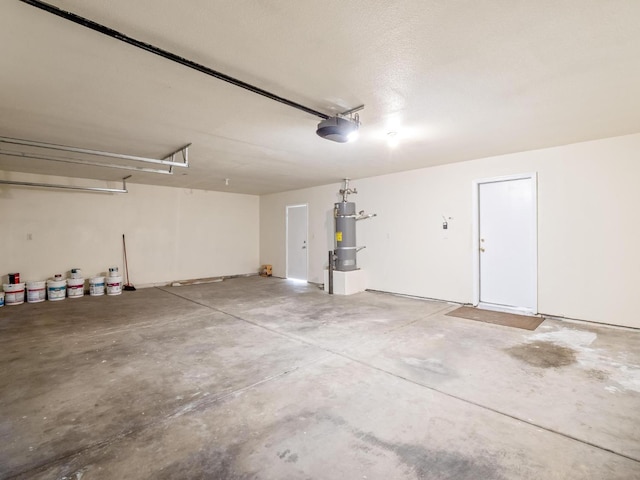5611 W Carmen Ave, Fresno, CA 93722 - garage with secured water heater and a garage door opener