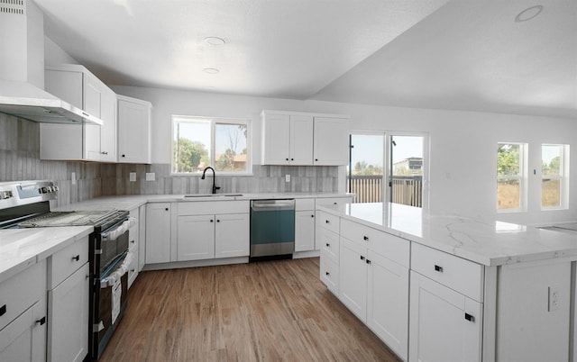 15758 Mark Rd, Madera, CA 93636 - kitchen featuring appliances with stainless steel finishes, wall chimney exhaust hood, light wood-style flooring, decorative backsplash, and a kitchen island