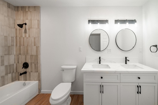 15758 Mark Rd, Madera, CA 93636 - full bathroom with toilet, double vanity, wood finished floors, and washtub / shower combination