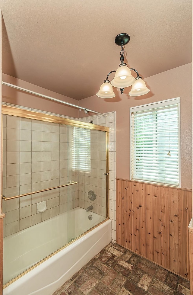 15501 Garlock Ln, Prather, CA 93651 - bathroom with a wainscoted wall, shower / bath combination with glass door, brick patterned flooring, and wooden walls