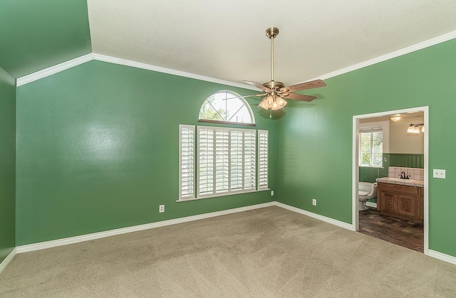 15501 Garlock Ln, Prather, CA 93651 - carpeted empty room featuring a sink, ceiling fan, vaulted ceiling, crown molding, and baseboards