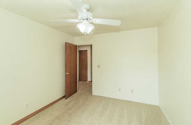 15501 Garlock Ln, Prather, CA 93651 - spare room featuring light colored carpet, baseboards, and ceiling fan