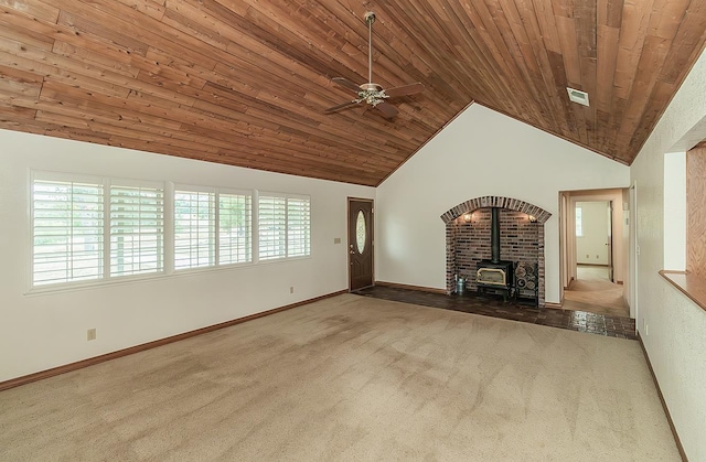 15501 Garlock Ln, Prather, CA 93651 - unfurnished living room featuring carpet floors, a wood stove, wood ceiling, vaulted ceiling, and baseboards