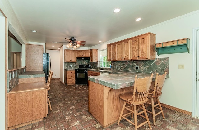15501 Garlock Ln, Prather, CA 93651 - kitchen with black appliances, a peninsula, brick floors, a kitchen breakfast bar, and baseboards