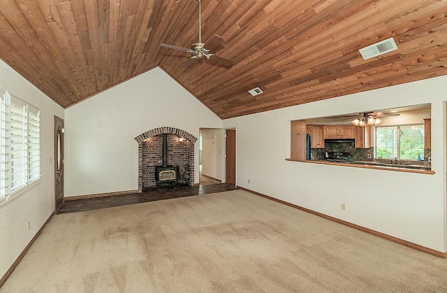 15501 Garlock Ln, Prather, CA 93651 - unfurnished living room with ceiling fan, a wood stove, carpet, vaulted ceiling, and wooden ceiling